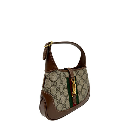lato  Borsa Gucci Jackie in canvas GG e pelle marrone, munita di un elemento allungabile per poterla portare comodamente a tracolla, di lusso, originale, eccellenti condizioni, usata.  