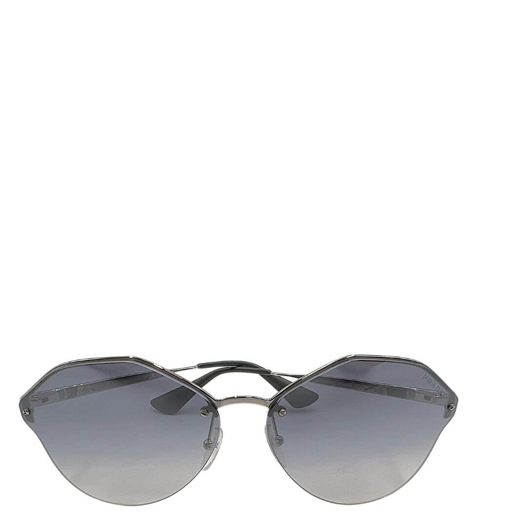 Foto occhiali da sole Prada con lenti trasparenti grigio. Accessori di lusso usati.